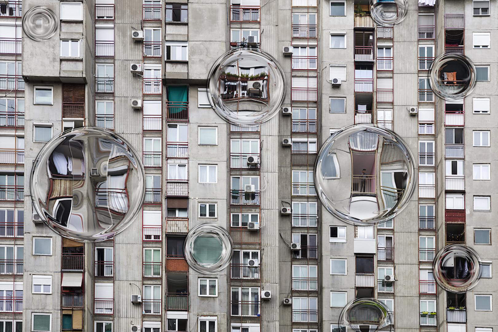 A group of bubbles floating in front of a buildingDescription automatically generated