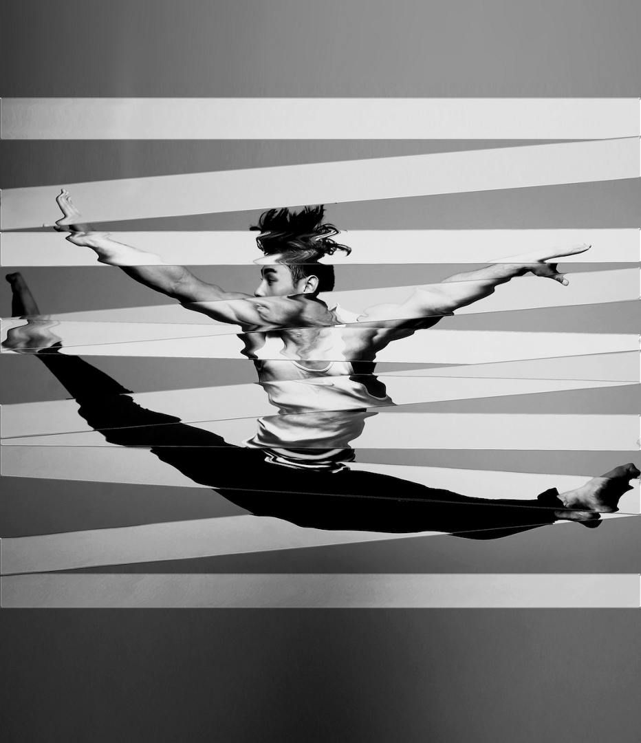 A person dancing with his arms outDescription automatically generated