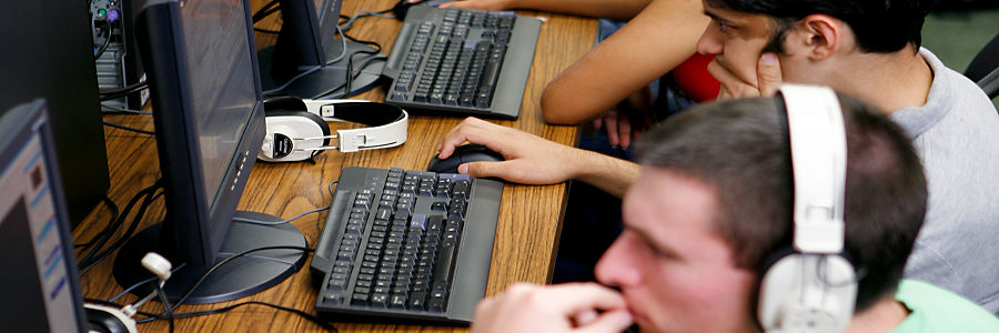 A person sitting at a desk with a computer mouse