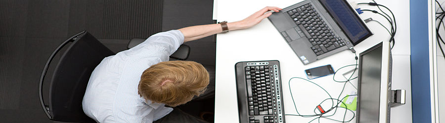 A person sitting at a desk with a keyboard