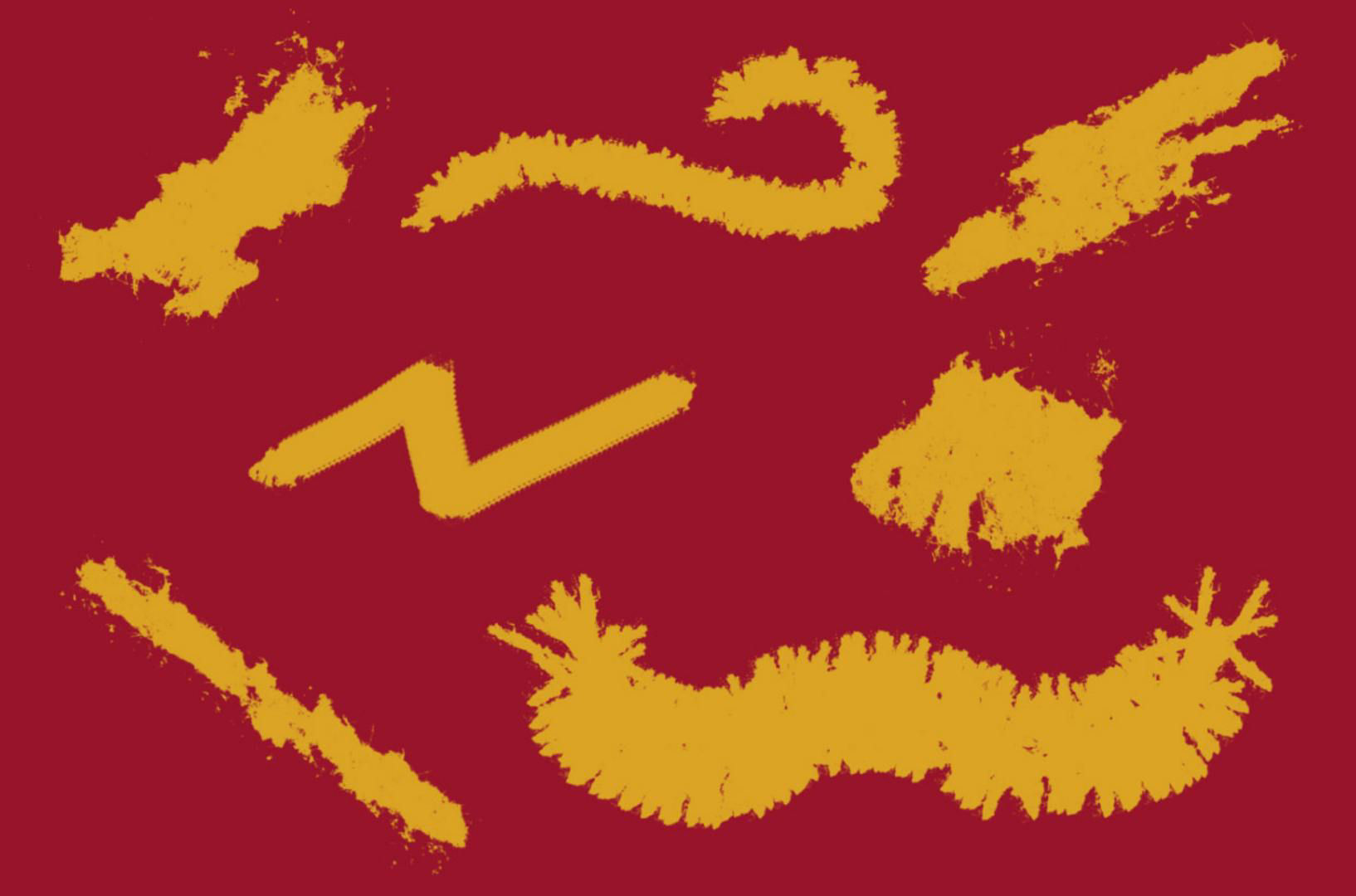 A series of grunge brush examples in yellow are displayed on a red background.