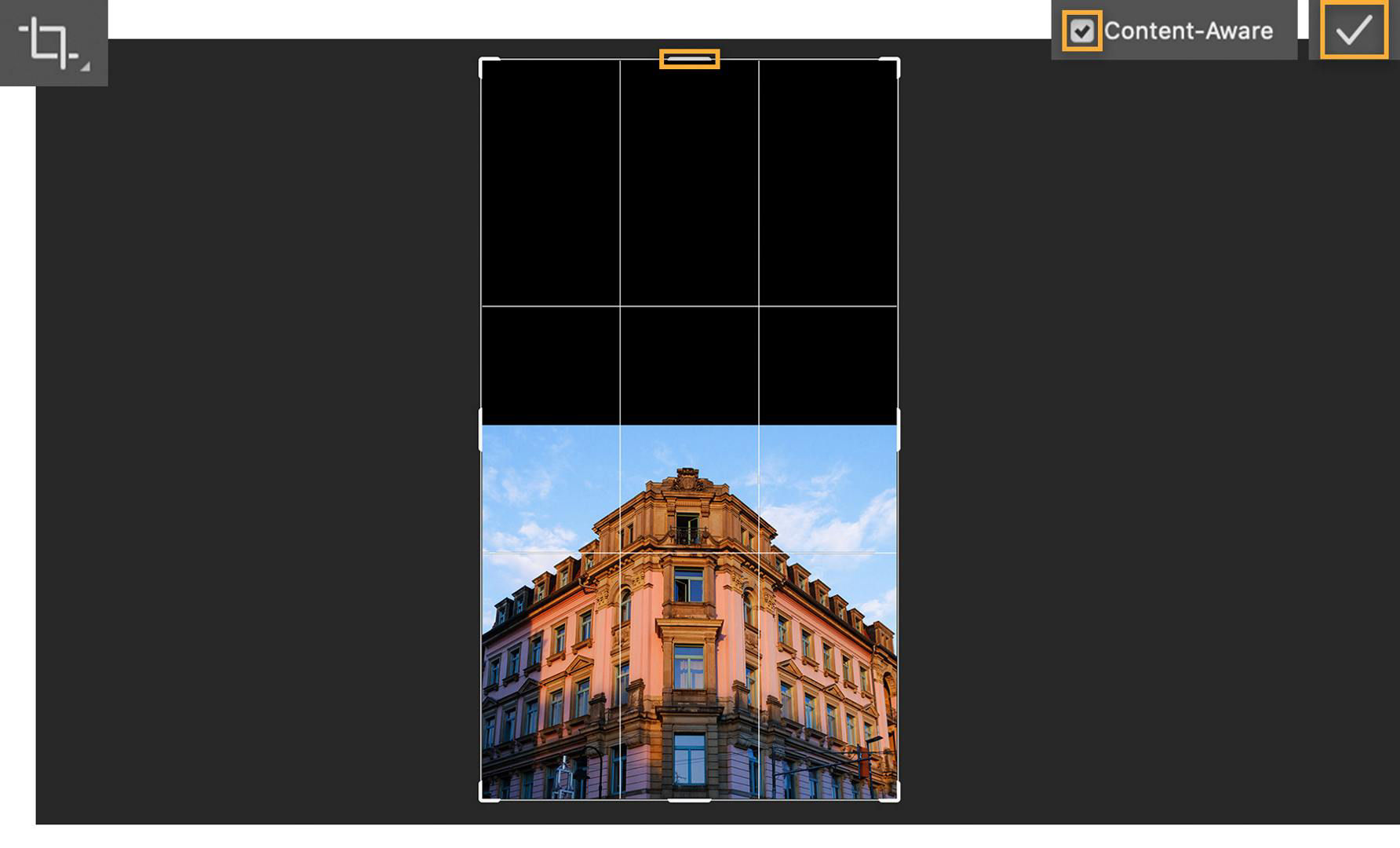 Canvas with the corner angle of a building is stretched using the Crop tool and Content-Aware is checked.