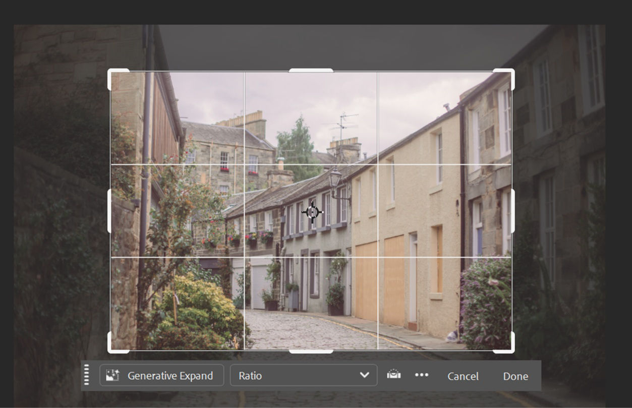 Photoshop workspace with the Crop tool active, showing a street scene framed by a rectangular crop boundary and grid overlay, with shaded areas outside the selection.