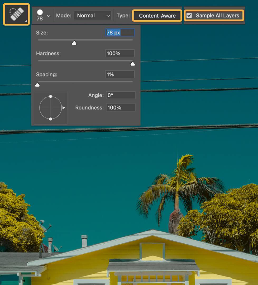 The Spot Healing Tool icon, which is a bandaid, is shown and the Content Aware and Sample All Layers options are highlighted in the Options bar.