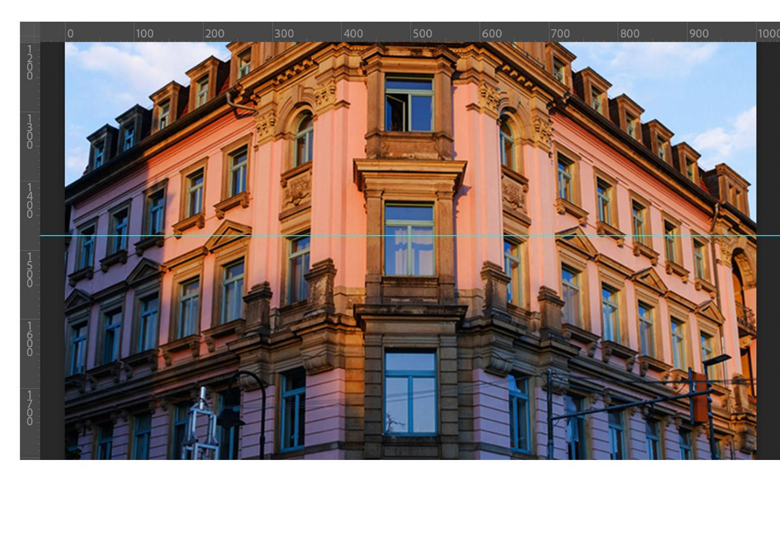 The building displays on the canvas with rulers on the top and bottom and a blue guide in the middle.
