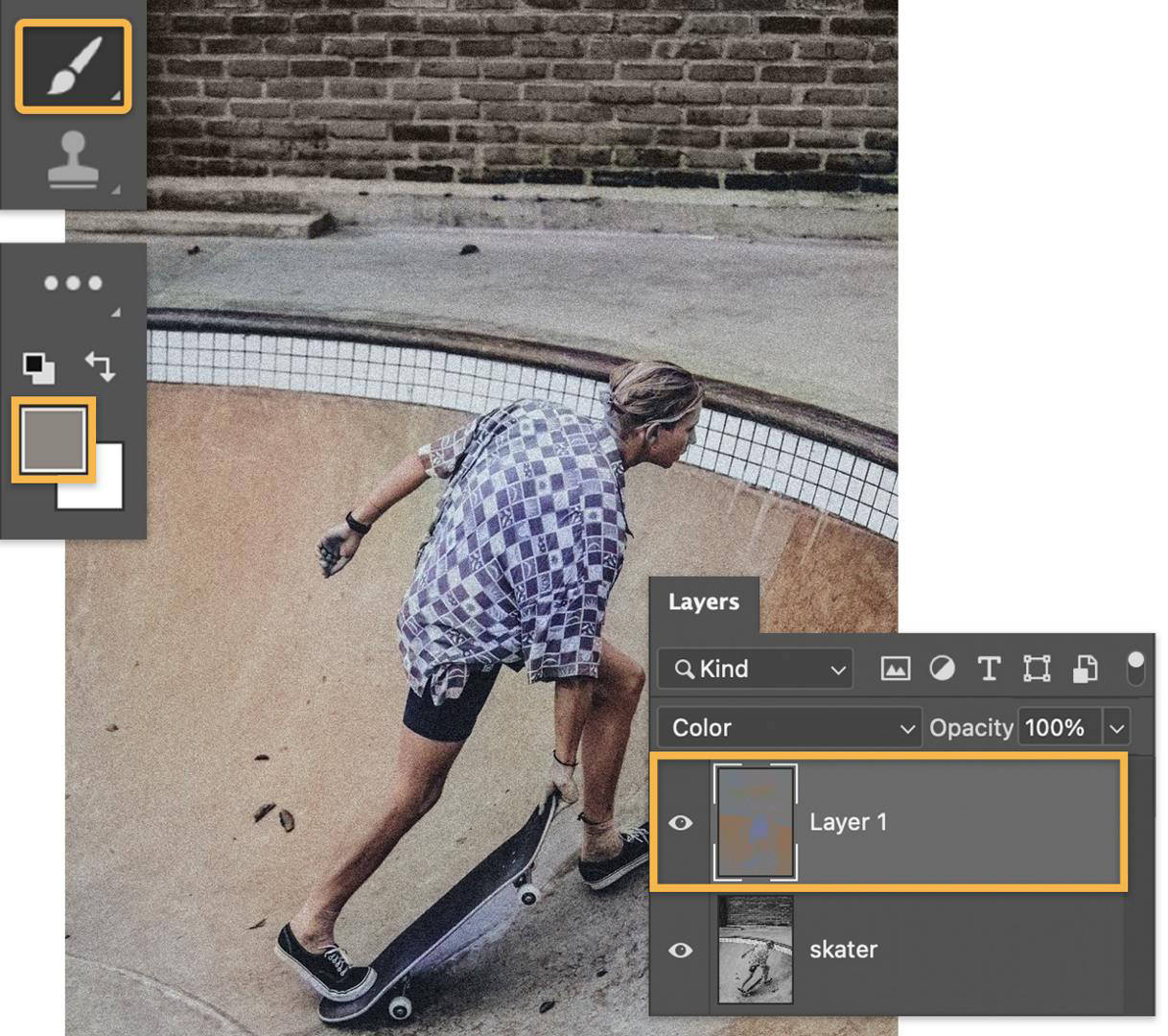 With the new layer selected in the Layers panel and the Brush tool in the tool bar, the brick wall behind the skateboarder is now colorized.