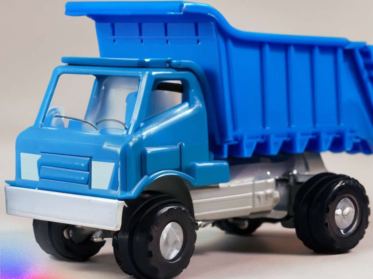 The image shows a toy dump truck with a blue body and a silver base. It's an example of using the Text to Image feature and a simple text prompt.