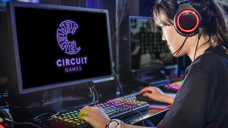 Girl wearing headphones sits at her computer watching the start screen for Circuit Games