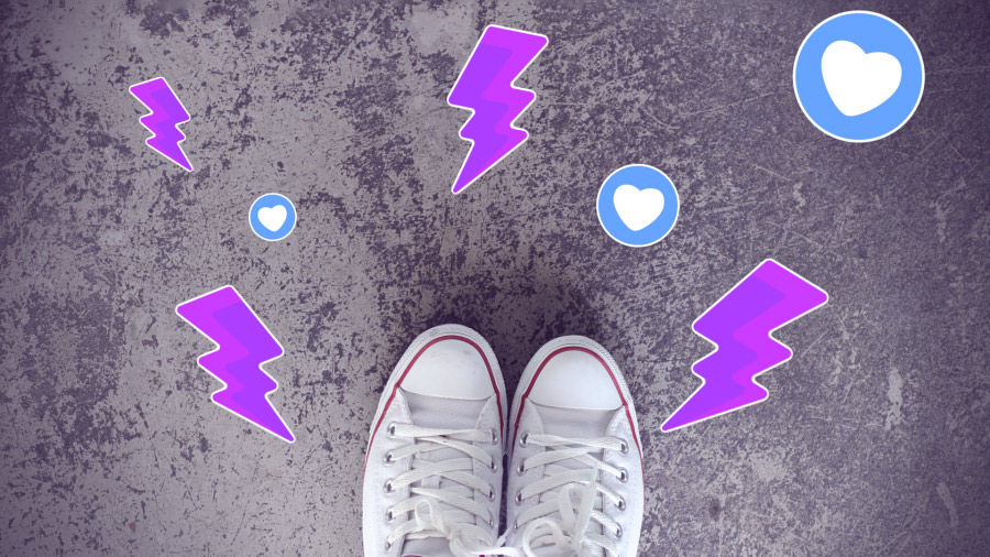 An image of sneakers on concrete, shot looking down, overlaid with lightning-bolt and heart stickers