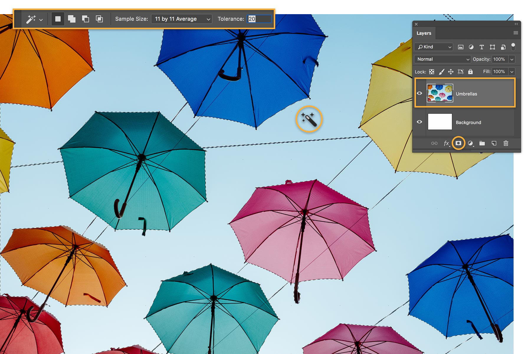 Magic Wand tool is used to select blue sky and isolate umbrellas. Umbrella layer and Add Layer Mask selected in Layers panel