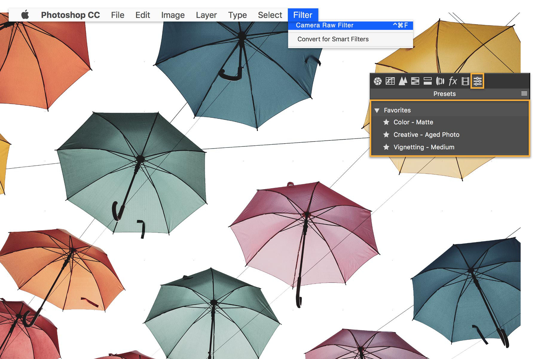 Artwork of umbrellas with Matte, Aged Photo, and Medium Vignetting Camera Raw Filters selected.