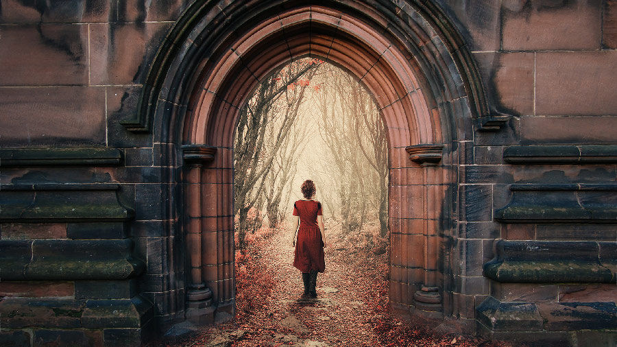 Woman in a red dress entering a building portal leading to a path in the woods
