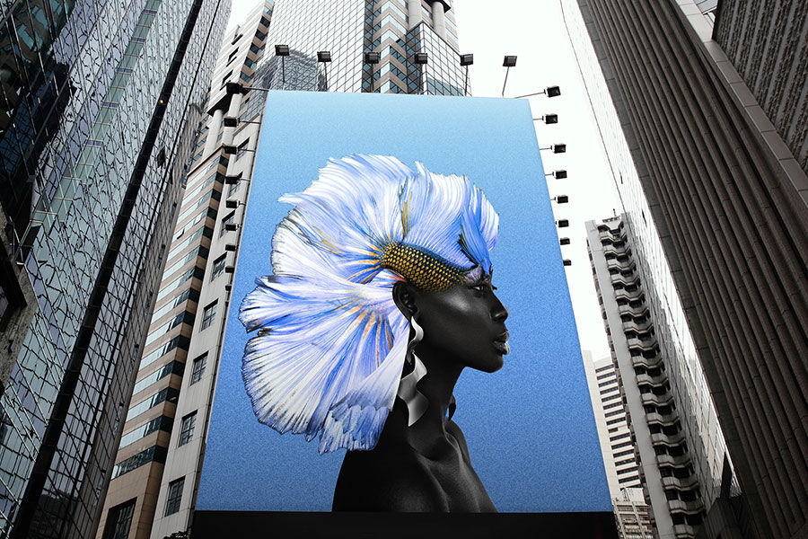 Tall skyscrapers in a city extend to the sky with a big billboard in the middle displaying final composite photo