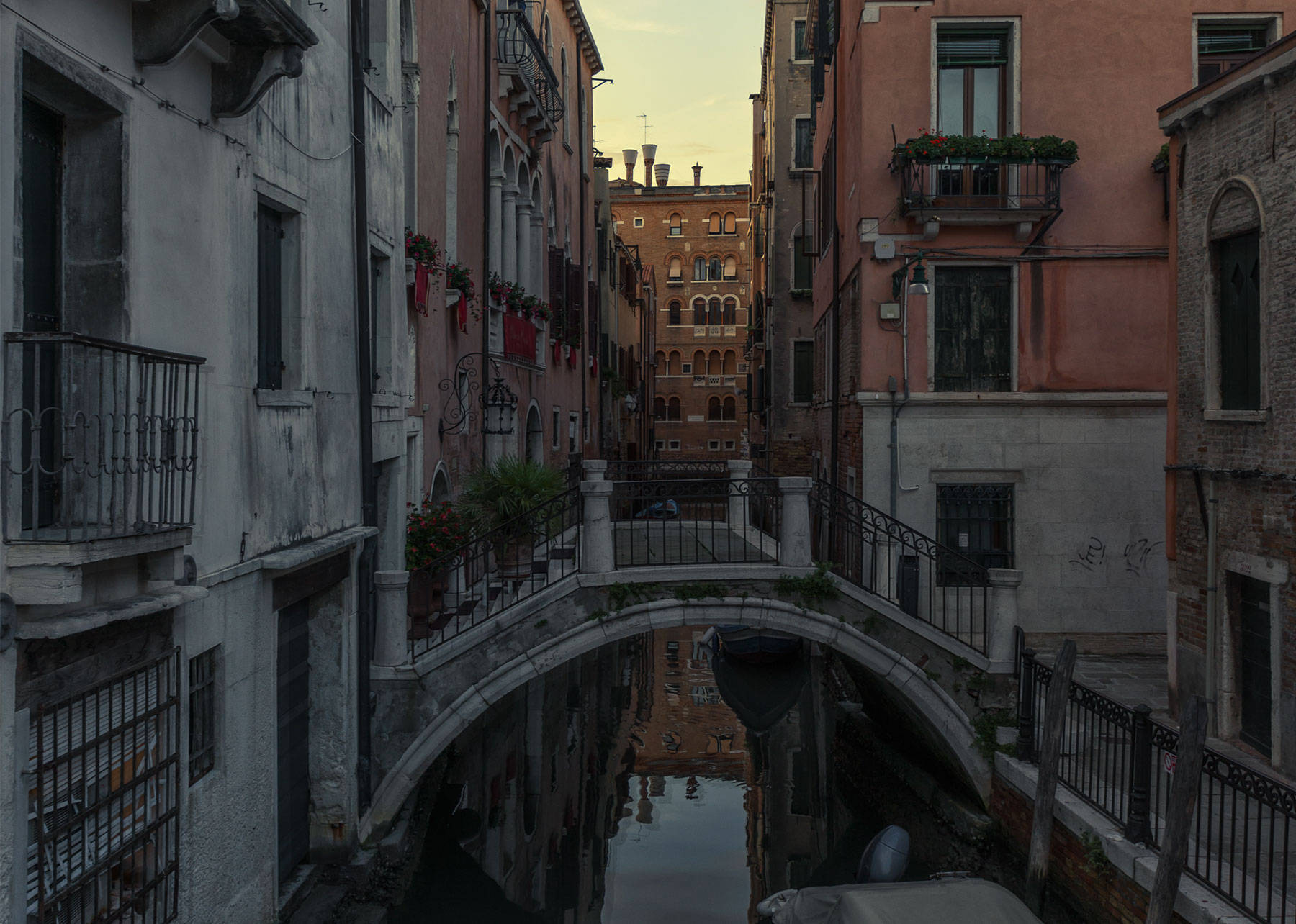 Italian buildings at dusk appear dark. 