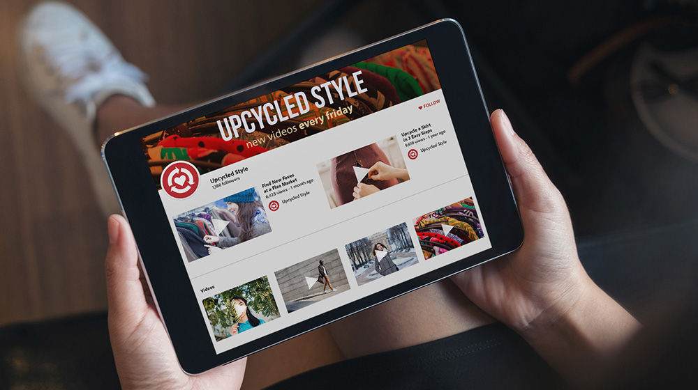 Person holding a tablet with Upcycled Style social media page opened. 
