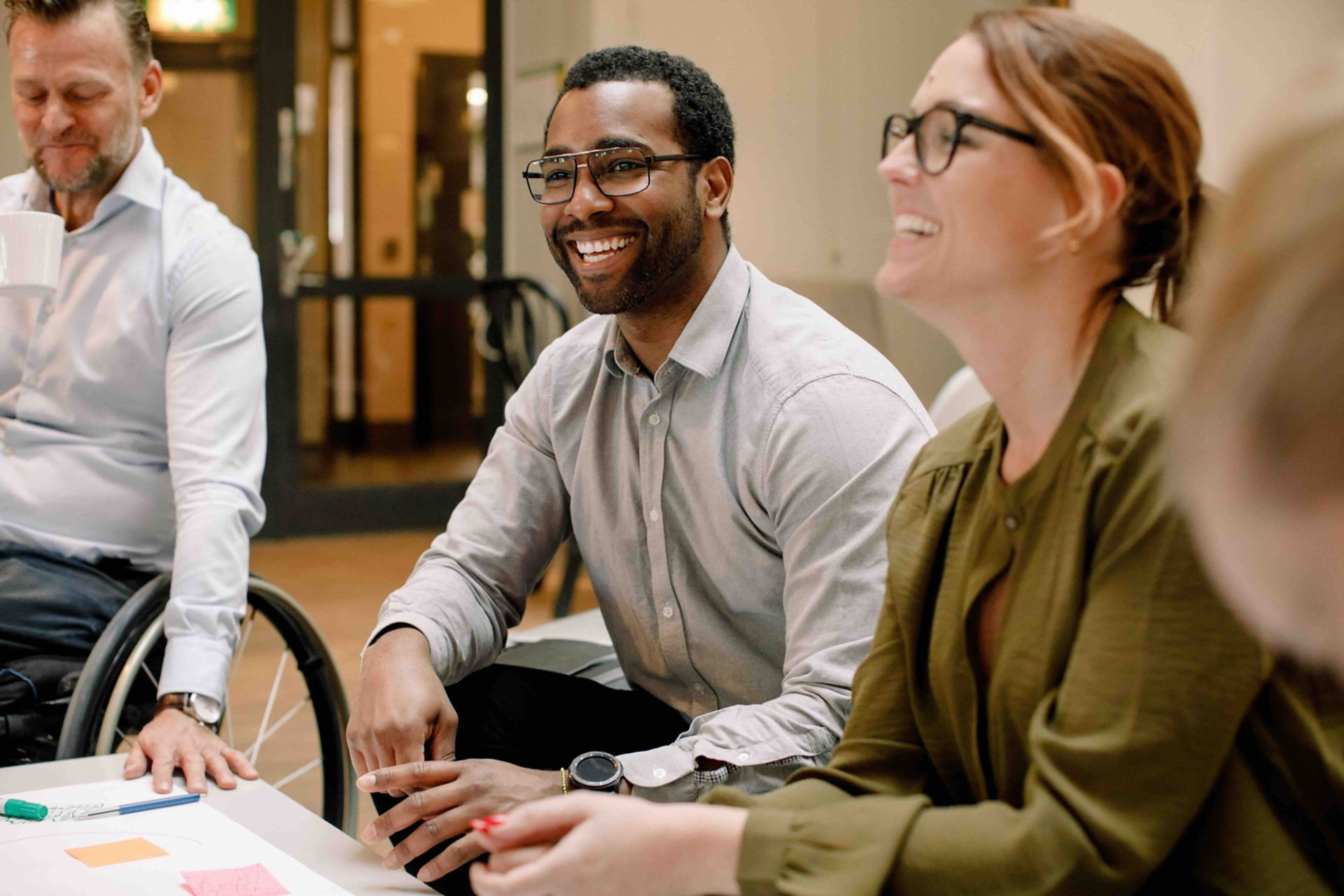 Three professionals in a meetingThe group appears engaged and smiling, suggesting a positive and collaborative environment.
