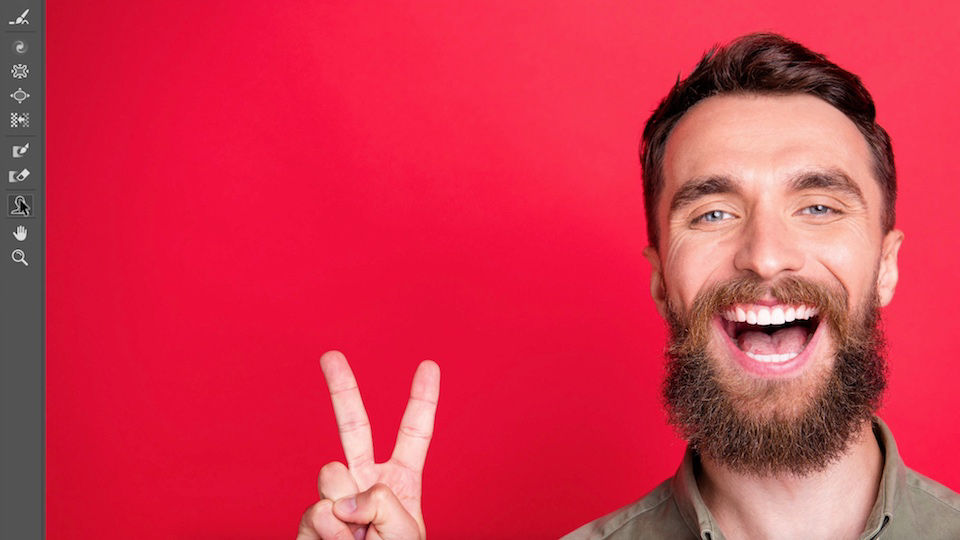 The Face tool is selected in the Toolbar next to artwork of a man smiling widely against a red background