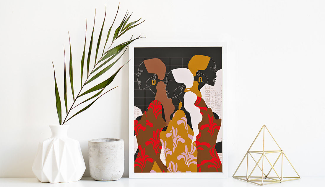 Fashion illustration displays in white frame on a white shelf next to a planter and a gold pyramid decoration