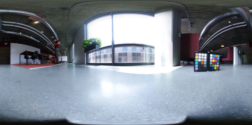 A 360 degree HDR panoramic of an office space with a color chart in the foreground.