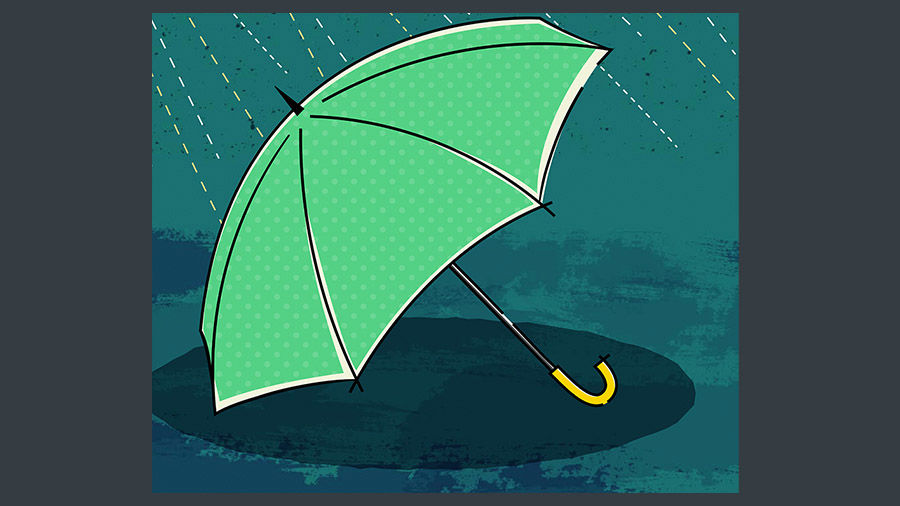 Light green umbrella sits on the ground in the rain. 