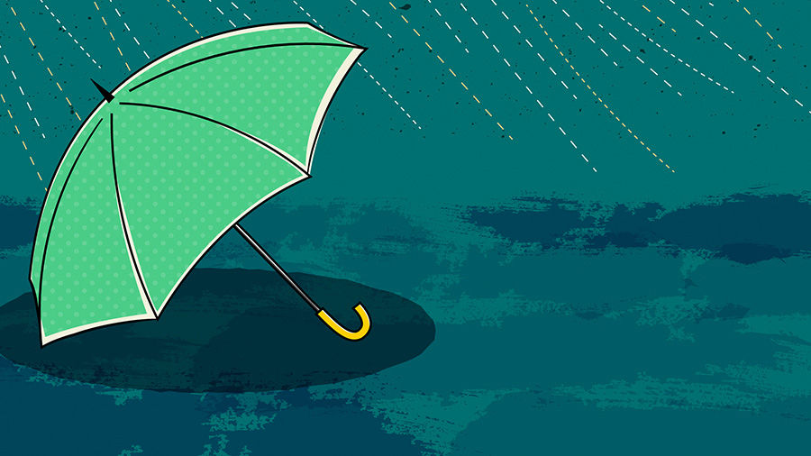 Light green umbrella sits on the ground in the rain. 