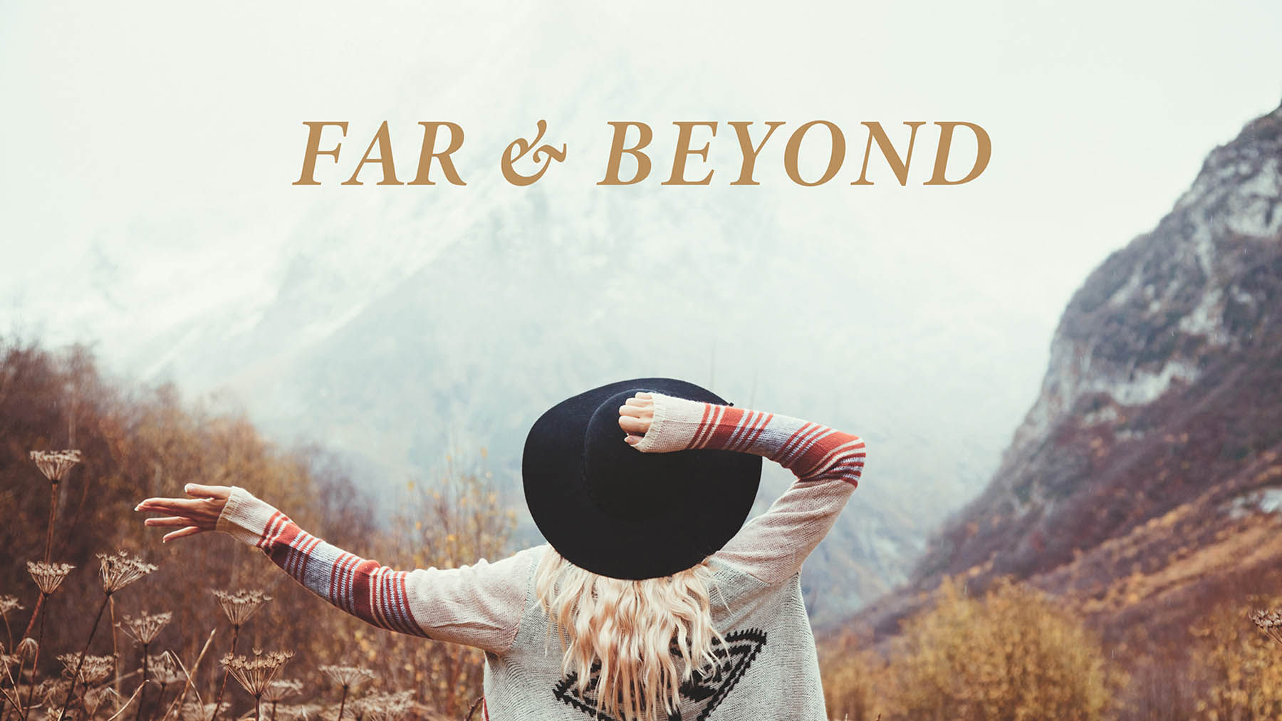Woman with hat and outstretched arm looks up at mountain. Light brown text “Far & Beyond” is at the top. 