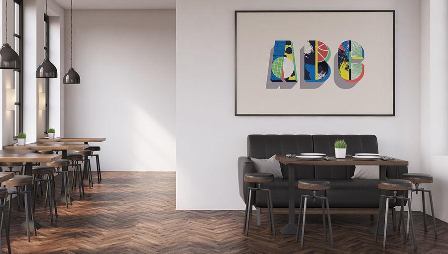 Letters ‘ABC’ filled with new textures from colorful images hangs in a frame on a wall in a restaurant