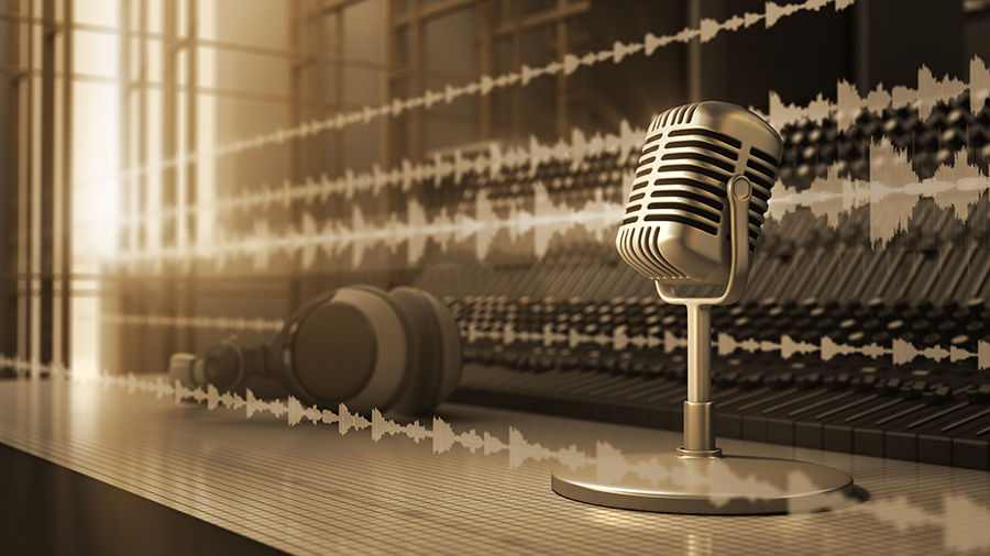 Sepia-toned image of multichannel audio streams displayed in the air behind behind microphone and headset. 