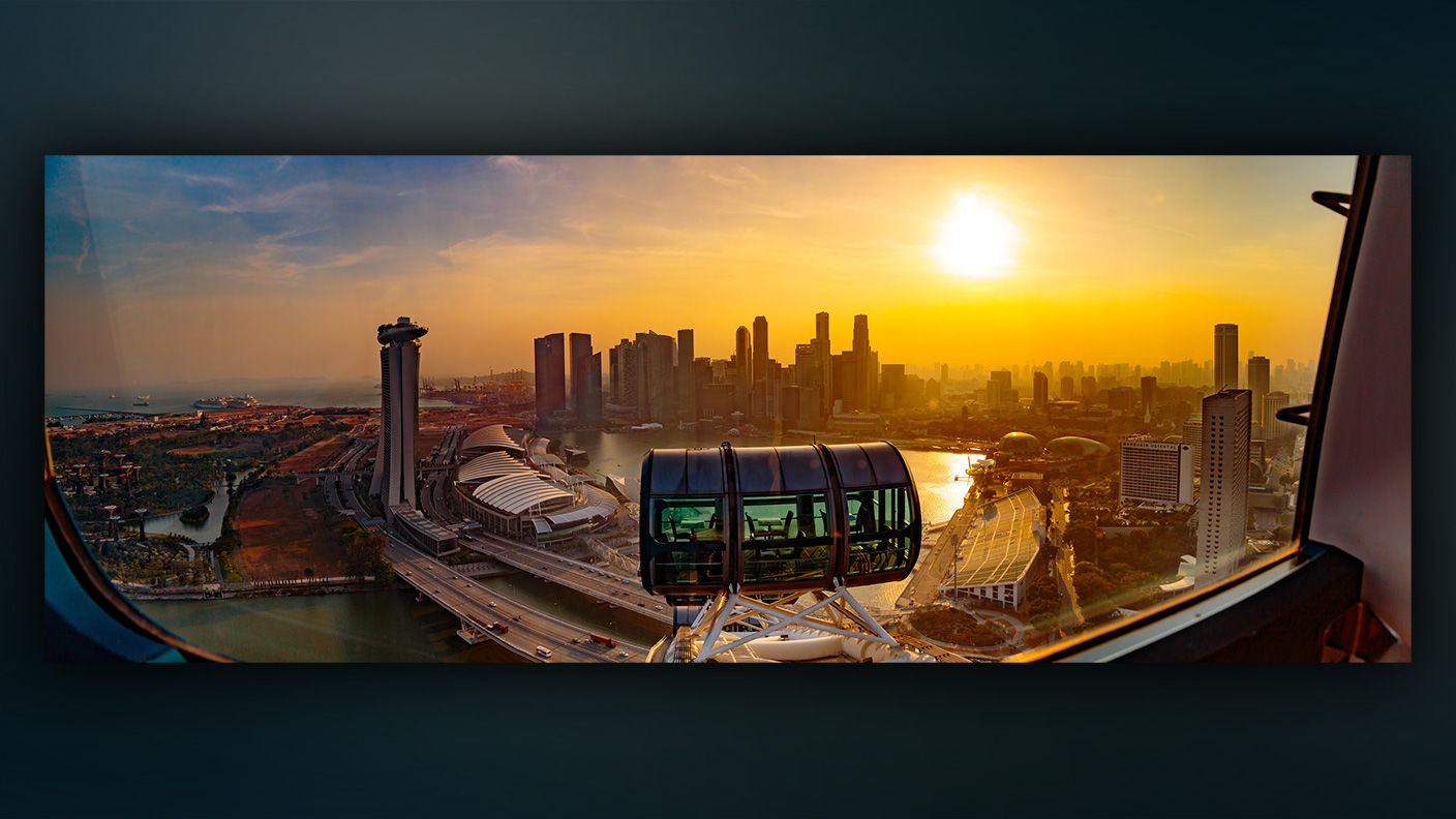 Panoramic view from a high-rise window of city skyline at dusk.