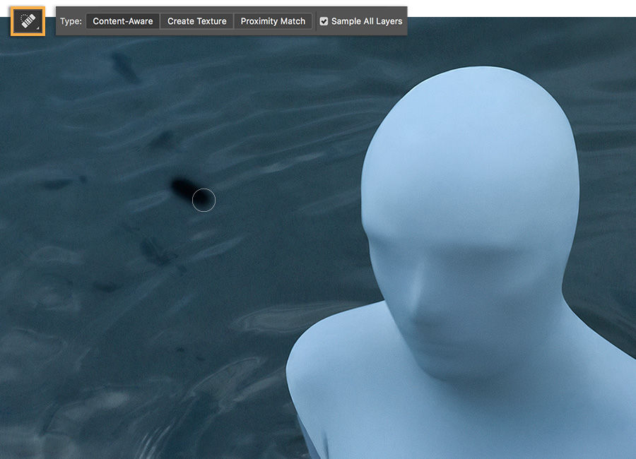 Spot Healing Brush, Content Aware type is used to remove imperfections around artwork of man in bodysuit. 