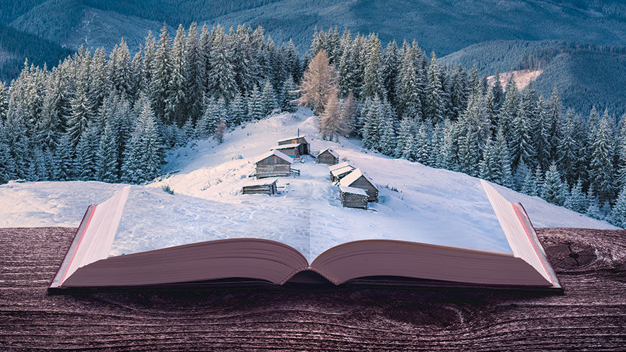 Image showing a village collaged onto an open book book on a ledge overlooking a snowy landscape