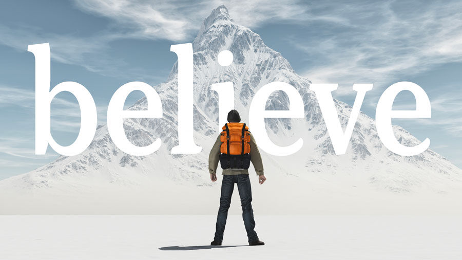 Image of a backpacker on a snowy mountainscape with the word "believe" over the photo
