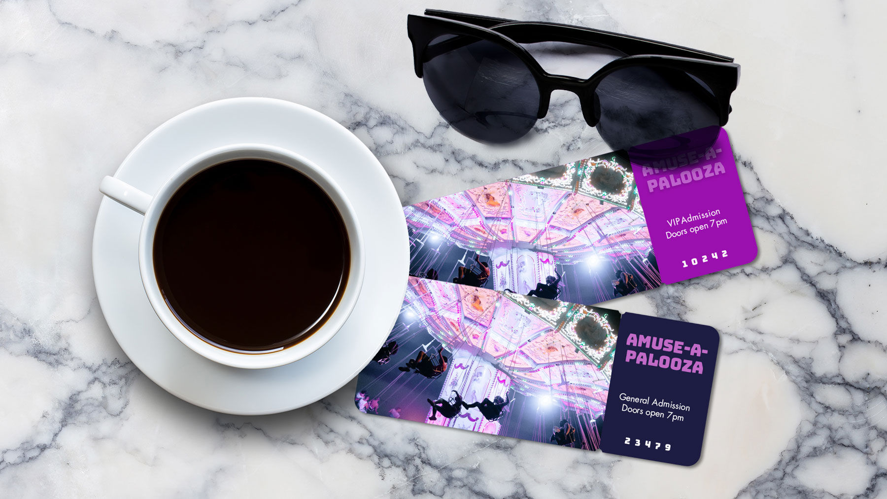 Overhead view of a cup of coffee, sunglasses, and amusement park tickets sitting on a marble tabletop.