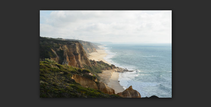 Corrected image of shoreline with grassy cliffs shows clearly defined transitions between land and water.  