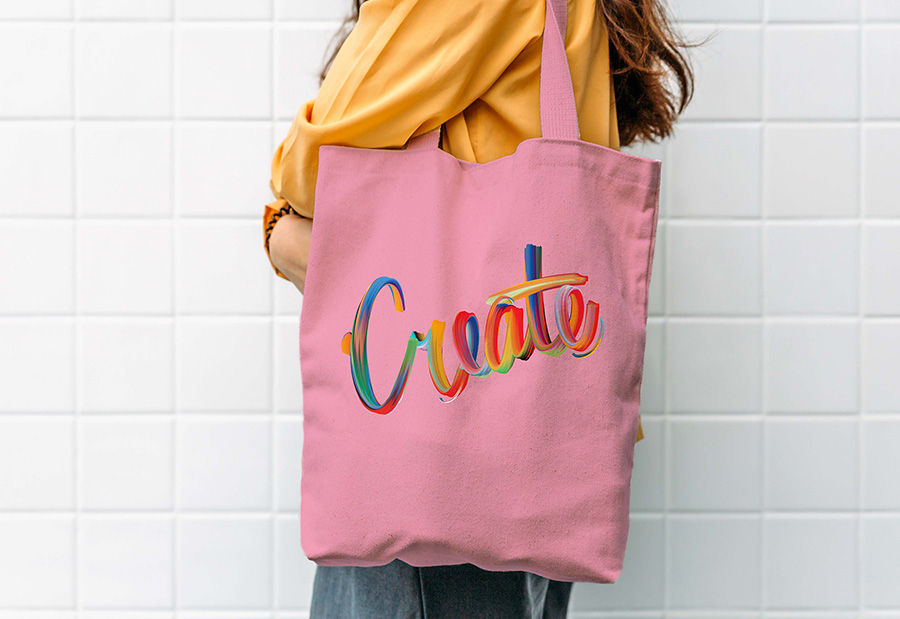 Hand lettering composition displayed on a pink bag on a model’s shoulder