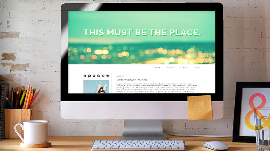 A computer monitor displays a website with a bold text header: This must be the place.