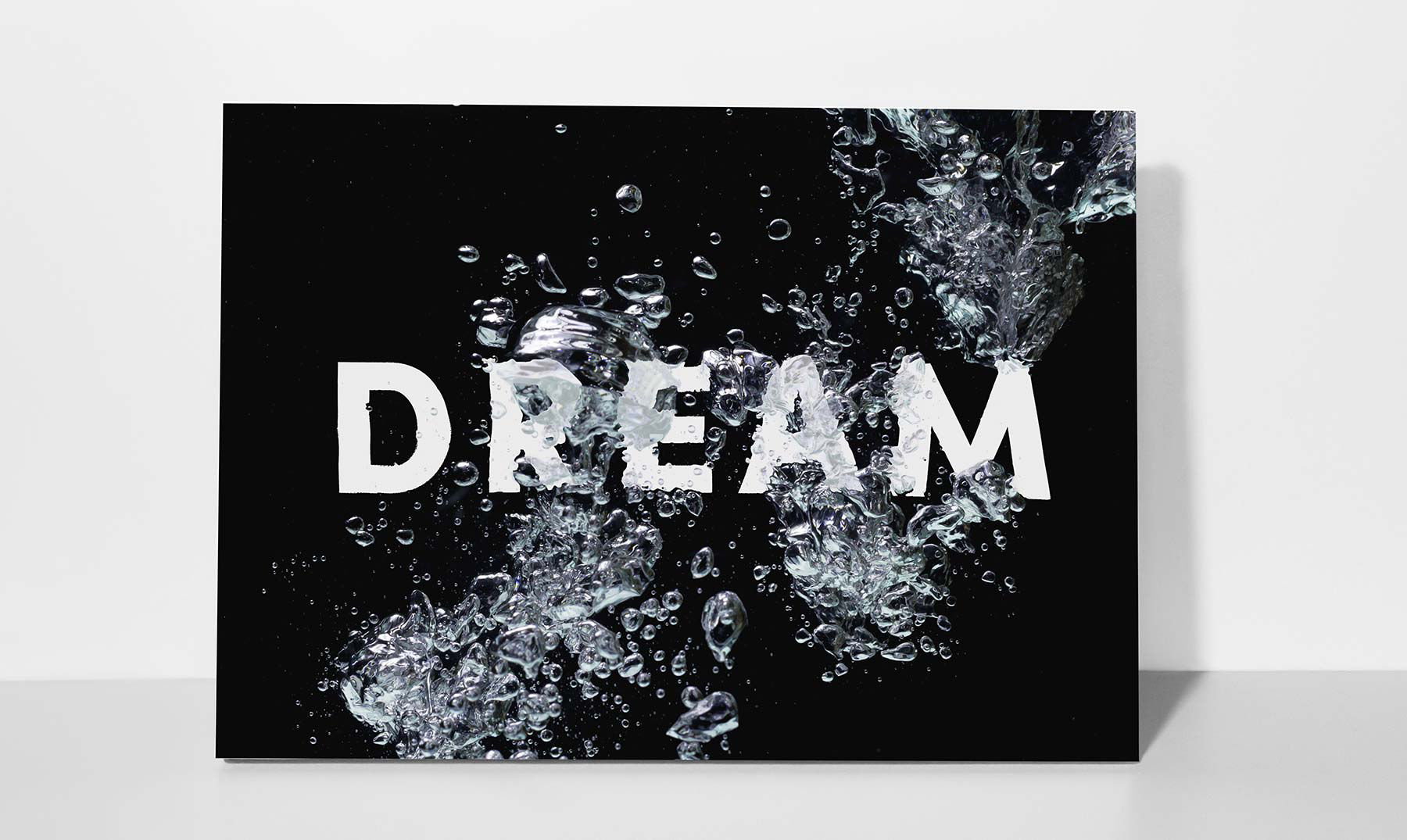 Completed composition shows the word DREAM appearing distorted by bubbles in water.