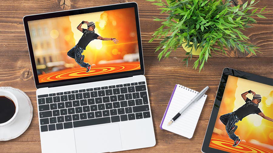 The same design of a dancer on a spiral dance floor displayed on the screen of a laptop and tablet
