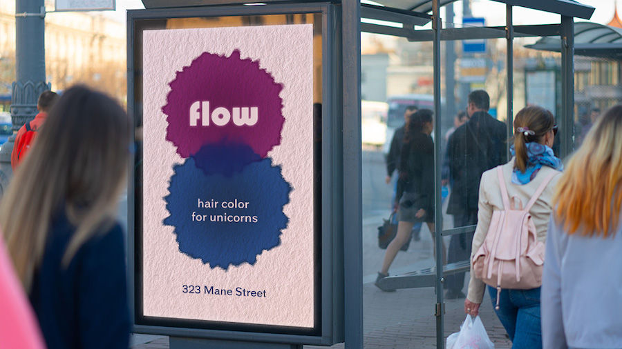 Digital display ad on bus shelter shows example of watercolors bleeding on textured paper as people walk by