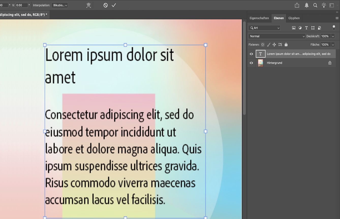 Eine Photoshop-Datei, in der der Beispieltext von einem Begrenzungsrahmen umgeben ist. Das Ebenenbedienfeld ist geöffnet und die Textebene ist ausgewählt.