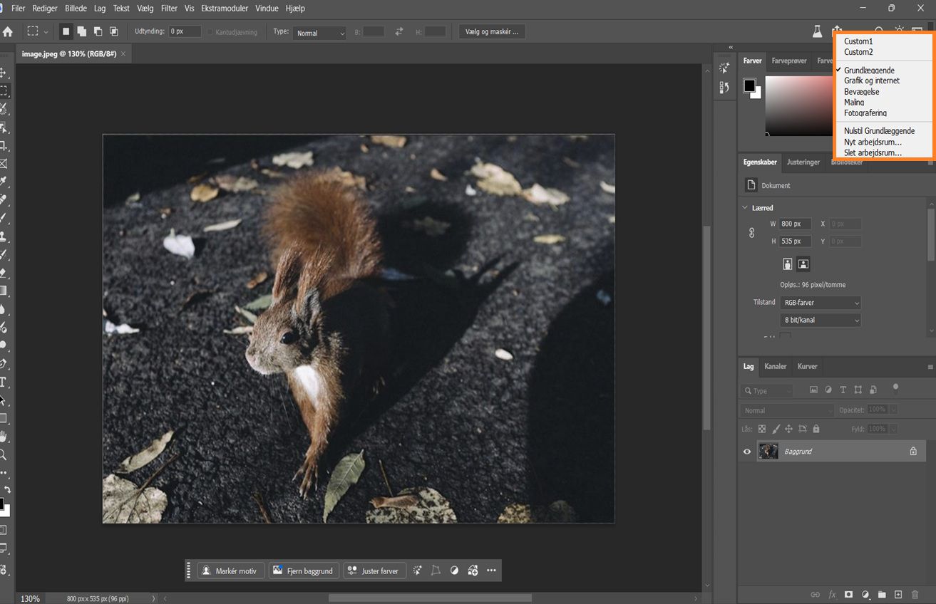 Photoshop-grænseflade, der viser rullemenuen Vælg et arbejdsrum med muligheder som Grundlæggende, Fotografi og tilpassede arbejdsrum.