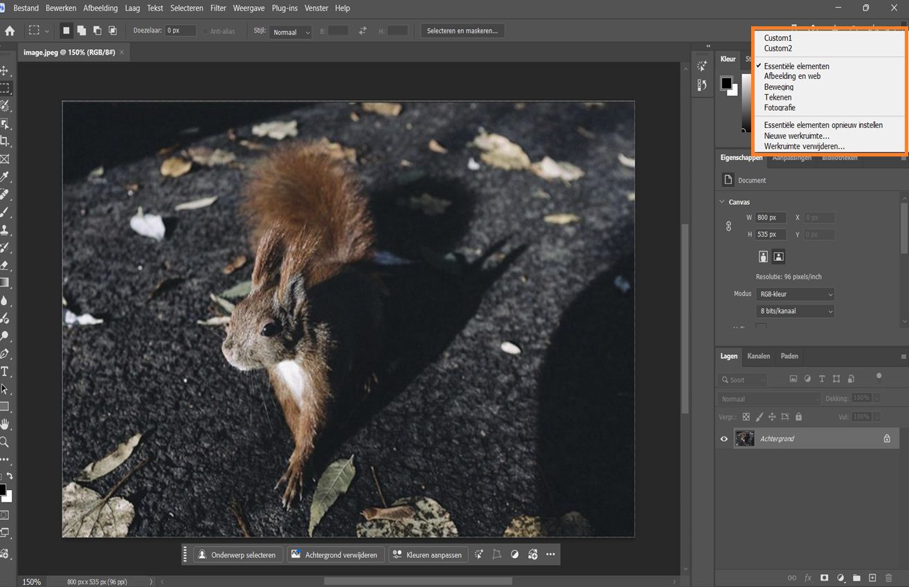 Photoshop-interface met het vervolgkeuzemenu Kies een werkruimte met options zoals Essentieel, Fotografie en aangepaste werkruimtes.
