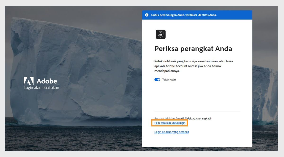 Halaman login Adobe, dengan jendela Periksa perangkat Anda, tempat Pilih cara lain untuk login disorot.