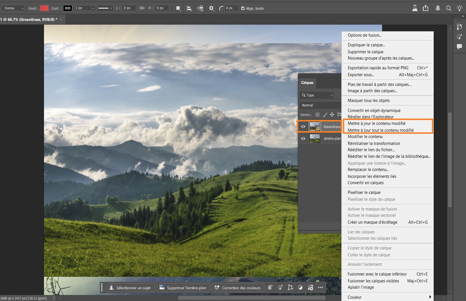 Le panneau Calques est ouvert et affiche un objet dynamique avec une icône d’avertissement jaune, indiquant que le fichier lié a été modifié et nécessite une mise à jour. L’icône d’avertissement jaune et les commandes de mise à jour sont mises en évidence. 