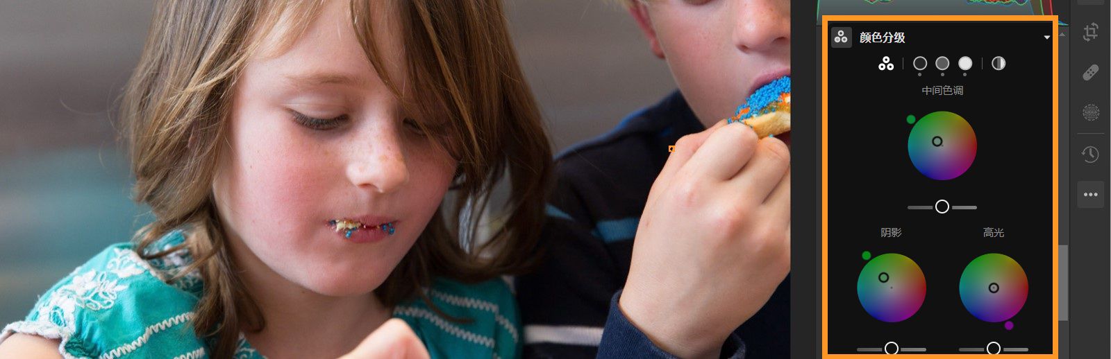 图像中显示有两个孩子，其中“颜色分级”面板在“编辑”面板中突出显示。 “中间色调”、“阴影”和“高光”对应的三个滑块均已设置。