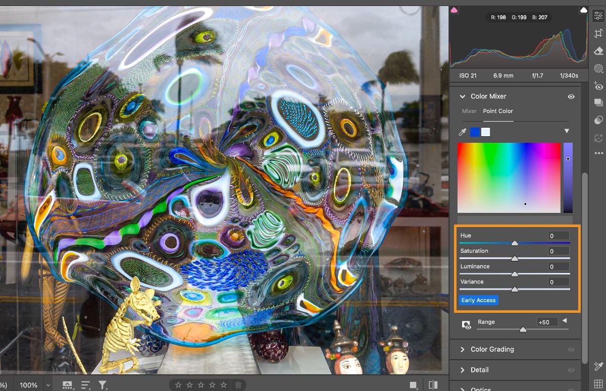 an image taken through a window with prominent reflection. The point color panel is highlighted in Camera Raw's editing panel.