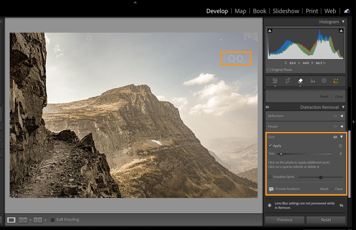 An image of a mountain with highlighted dust stops due to camera sensor is opened in Lightroom Classic with the Distraction Removal panel open. The Dust feature removes these sensor dust spots. 