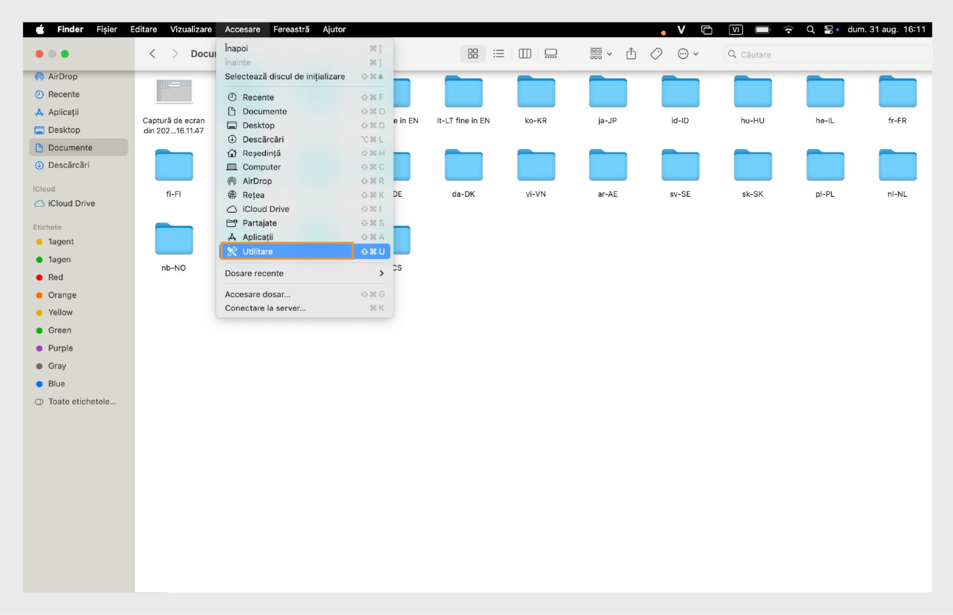 Fereastra Finder din macOS evidențiind folderul Utilitare în bara laterală din stânga.