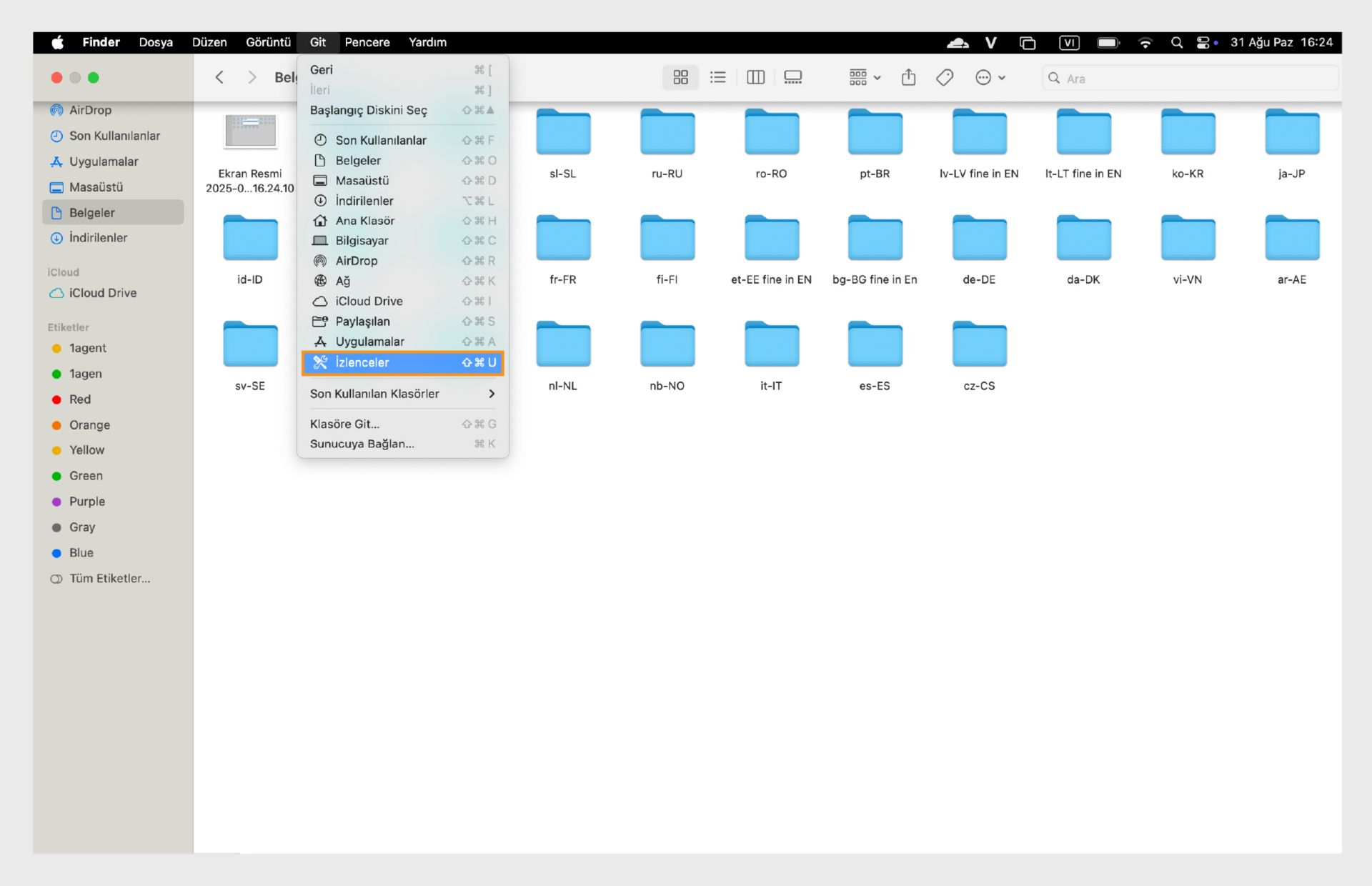 Sol kenar çubuğunda Yardımcı Programlar klasörünü vurgulayan macOS Finder penceresi.