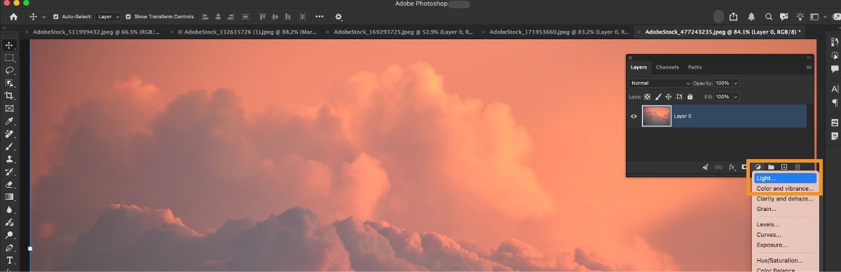 Adjustment layer menu open in the Layers panel with Light option highlighted above a sunset cloud photo.